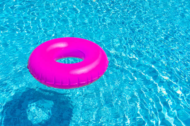 istock Violet ring floating in blue swimming pool. Inflatable ring, rest concept 1419897764