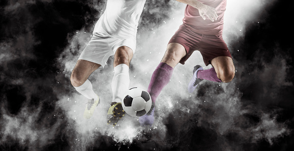 Two soccer player in action on smoke background