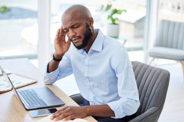 istock Burnout, headache and stressed businessman working on laptop with problem, bad mental health or stressful job. Male manager rubbing head and feeling overworked, tired or exhausted at web tech company 1419903099