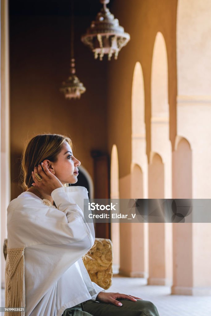 Woman in meditation space latin woman sitting on bench and waiting in meditation space in morocco Morocco Stock Photo
