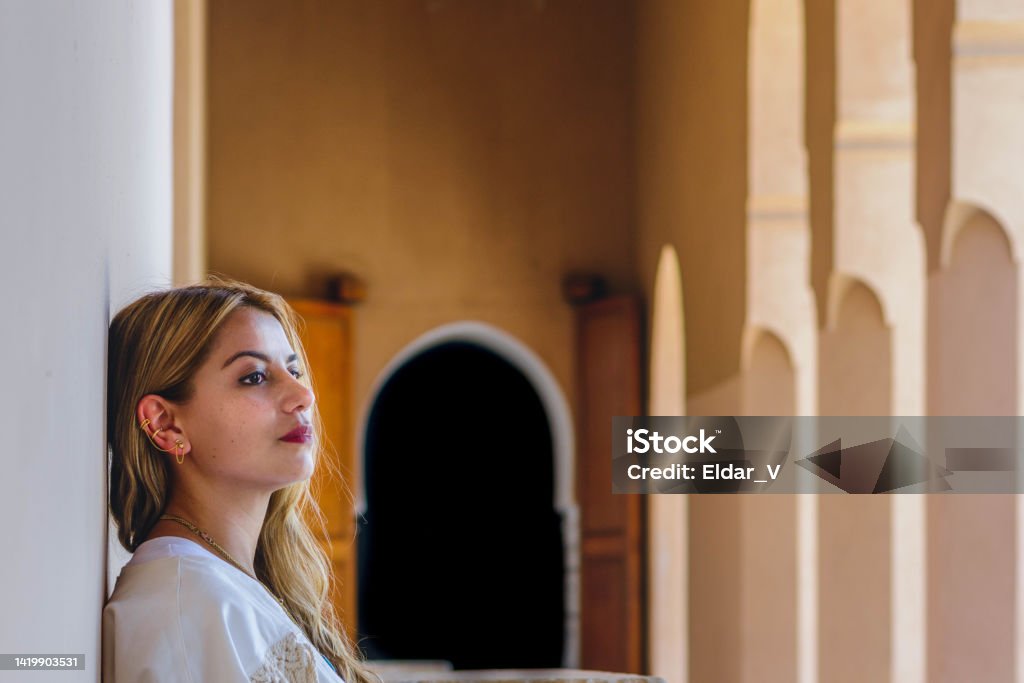 Woman in meditation space latin woman sitting on bench and waiting in meditation space in morocco Active Lifestyle Stock Photo