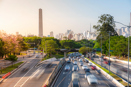 View to the avenue and Ibirapuera neighborhood with the Obelisk at background, long exposure with blurried cars