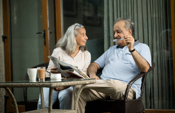 istock Old Couple Reading Newspaper And Smiling 1419905416
