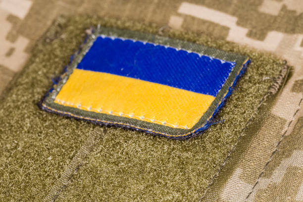 istock Ukrainian flag patch on camouflage uniform, close-up selective focus 1419905791