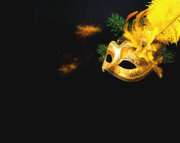 istock Masquerade mask on black background with confetti. New Years decor. Blurred effect. Close-up 1419906523