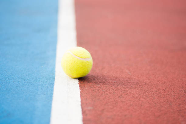 Tennis ball lying on the court