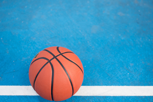 Orange Basketball ball on the blue surface