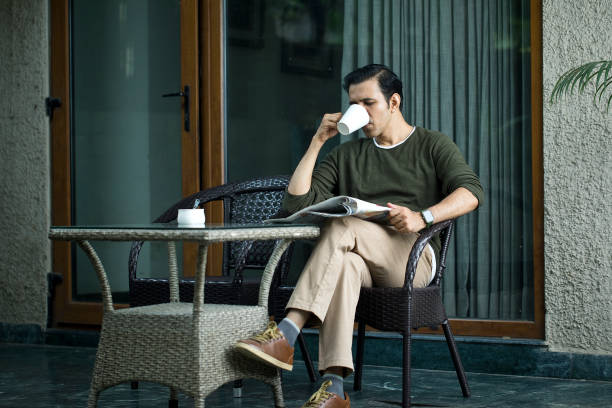 istock Mid Adult Man Reading A Newspaper And Drinking Coffee 1419908251