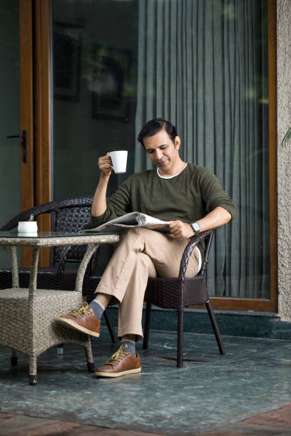 istock Mid Adult Man Reading A Newspaper And Drinking Coffee 1419908299