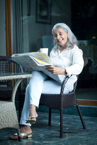 istock Senior woman Reading Newspaper 1419910410