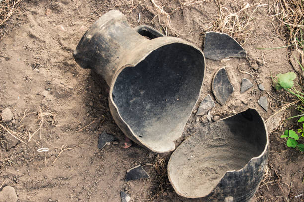 Broken earthenware jug for wine on the ground. Excavations of ancient clay jugs. stock photo