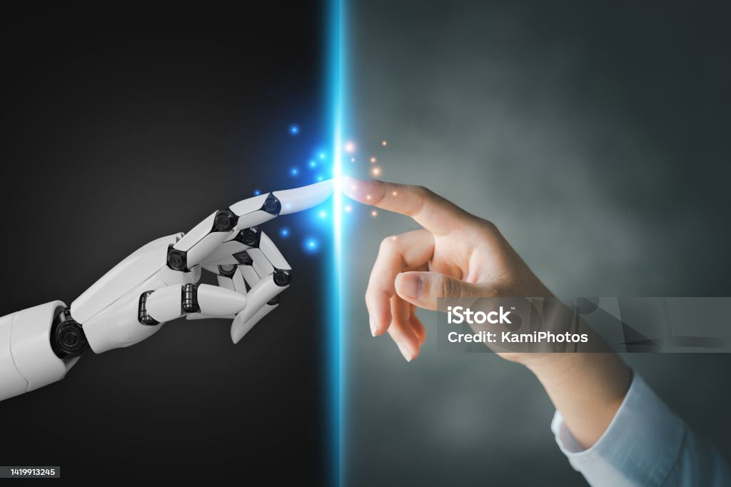 Robot and human hands pointing to each other, the idea of creating futuristic AI, intelligent systems to work instead of humans and do what humans can't. Creating innovative technology of the future. Artificial Intelligence Stock Photo