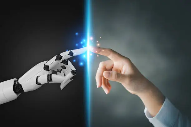 Photo of Robot and human hands pointing to each other, the idea of creating futuristic AI, intelligent systems to work instead of humans and do what humans can't. Creating innovative technology of the future.