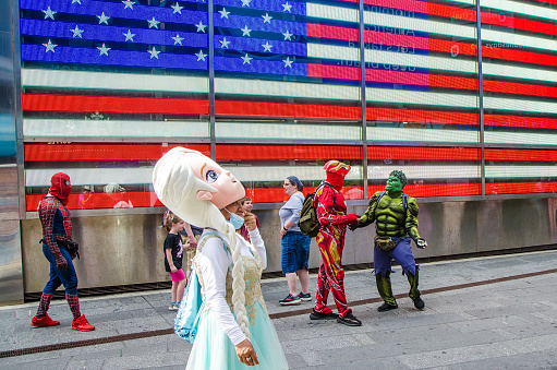People disguised in superheroes to make money when you want to be taken in pictures with them on the streets of New York during summer day