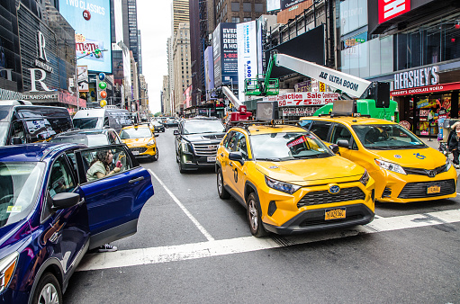 New York city street with yellow cabs during summer day