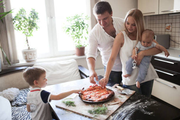 istock family with two sons eating pizza, lifestyle 1419917616