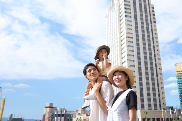 Asian family walking to an event and enjoying a tour stock photo