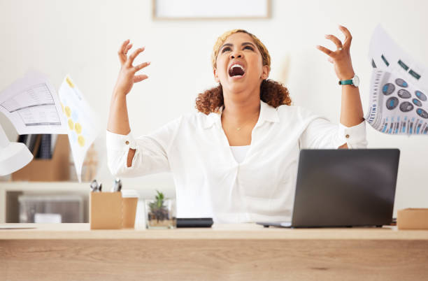 istock Angry, stressed and unhappy finance manager throwing documents and paperwork. Annoyed, irritated and screaming financial boss, leader and woman making a mistake or failing a tax deadline on laptop 1419920476