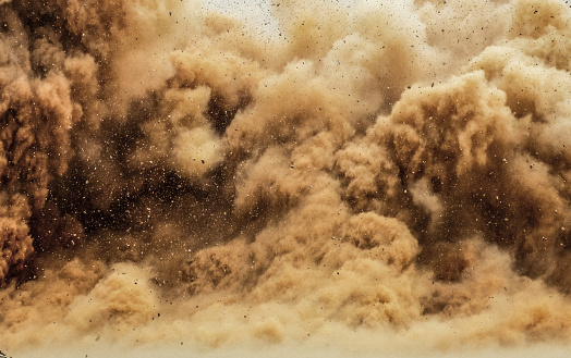 Flying rock particles and dust storm during dynamite blast in the Arabian desert
