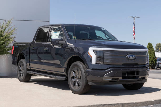 Ford F-150 Lightning display. Ford offers the F150 Lightning all-electric truck in Pro, XLT, Lariat, and Platinum models. stock photo