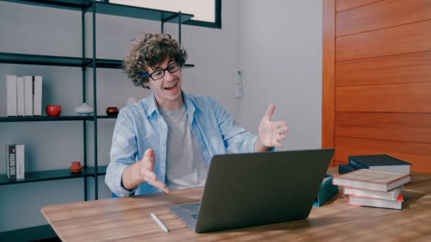 istock Young Adult Man Giving an Energized Presentation during Online Class. 1419924332