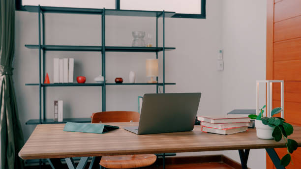 Table with Laptop and Studying Supplies, Ready for Upcoming Online Class.
