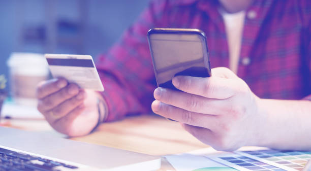 istock businessman using Credit card verifies account balance on mobile banking application.Online payment shopping,selective focus,vintage color,business concept 1419928886