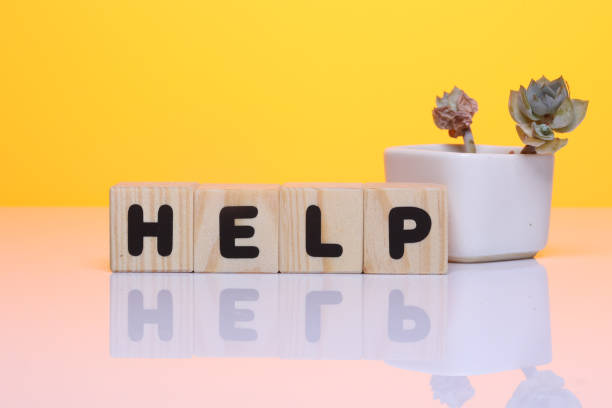 istock HELP word on wooden block  on yellow background 1419930092