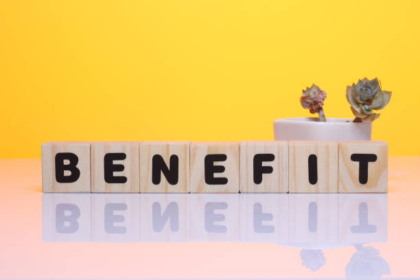 istock BENEFIT word on wooden block  on yellow background 1419930263
