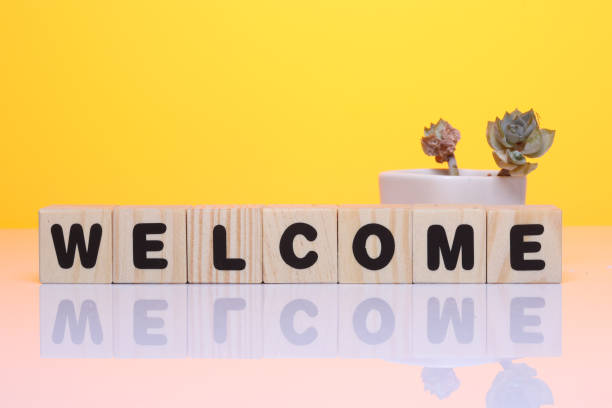 istock Welcome word on wooden block  on yellow background 1419930318