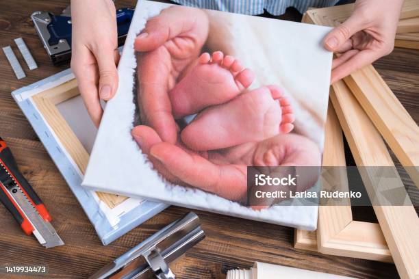 The Master Demonstrates A Photo Of Childrens Legs Printed On Canvas And Stretched On A Stretcher Stock Photo - Download Image Now