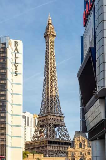 Las Vegas, USA - May 23, 2022:  Eiffel Tower and city hotels along The Strip on a sunny day.
