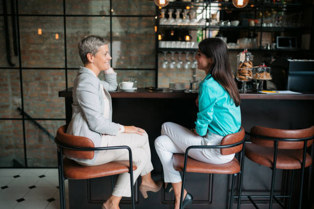Two businesswomen meeting in a coffee shop stock photo