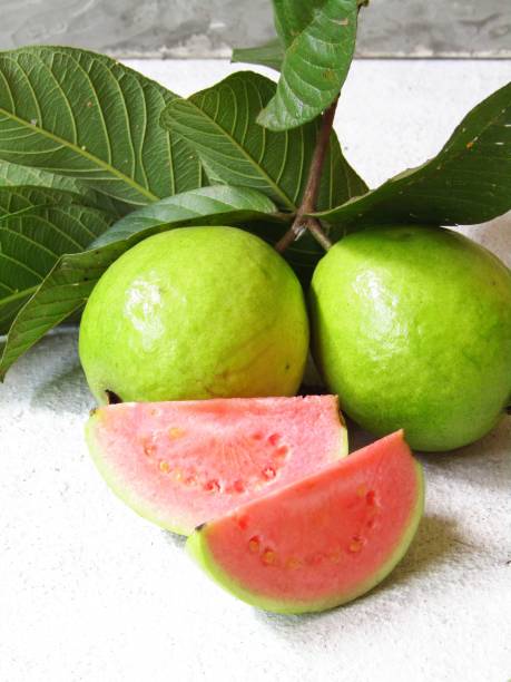 istock Guava with stalks and leaves on the table 1419938549