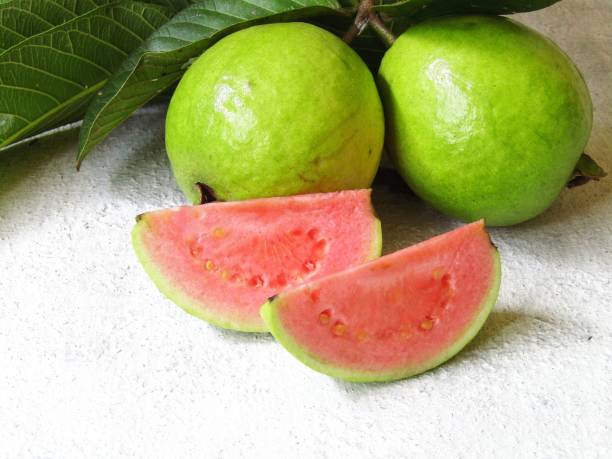 istock Guava with stalks and leaves on the table 1419938562