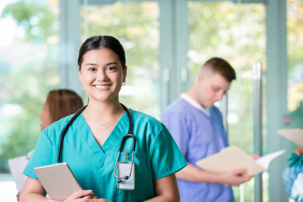 Portrait of medical intern in busy hospital stock photo