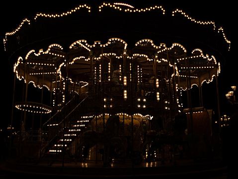 Focus on the lights of a merry-go-round in Paris