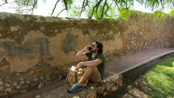 istock Man talking on a cell phone in a park 1419942430