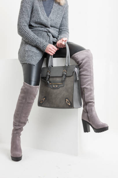istock gray women's boots with a handbag 1419945401