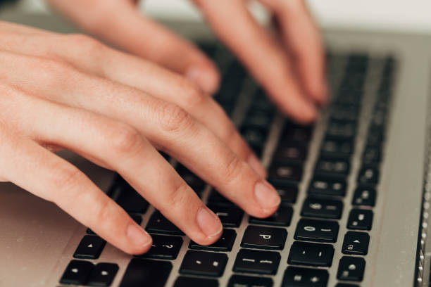 istock Close-Up Shot of Human Hands Placed Over Laptop 1419946154
