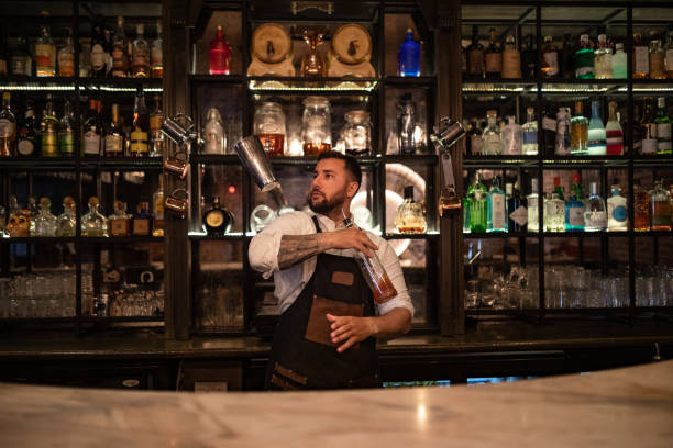 istock Professional bartender enjoys making alcoholic cocktails 1419948301
