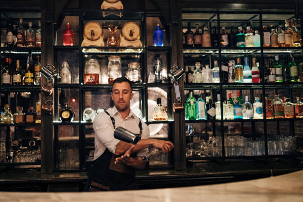 istock A bartender in a white shirt makes cocktails using a shaker 1419948475