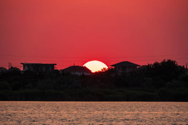 The sun goes down over a lake. Dramatic Sunset Sky