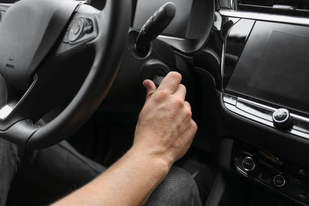 istock MAN HOLDING IGNITION KEY IN CAR 1419957383