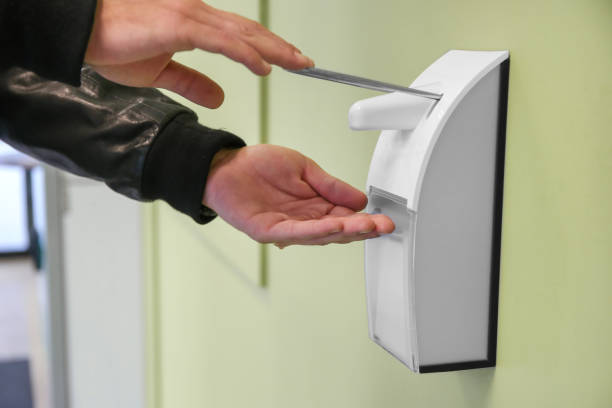 istock male hand with antibacterial gel from automatic sanitize machine hanging on building wall healthcare concept outdoor 1419957763