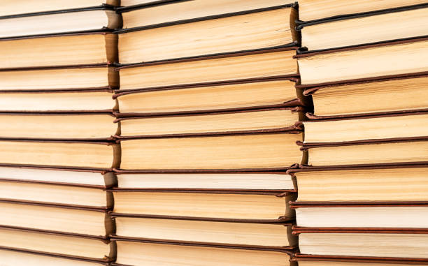istock Many stacked hardcover books in library, bookstore. Knowledge, wisdom, learning concept. 1419958580