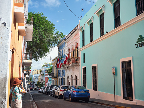 Tourist taking photograph of the colorful streets in Old San Juan, Puerto Rico