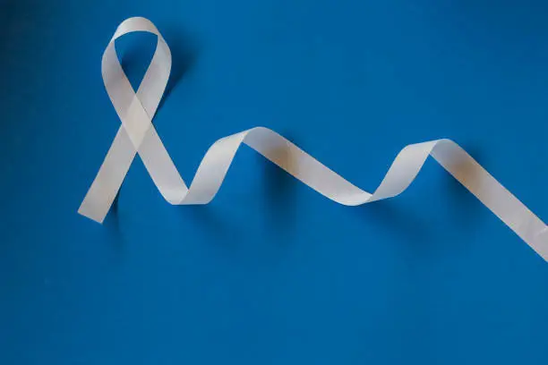 white January, mental health awareness campaign. white ribbon on blue background