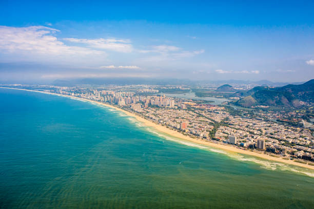 The coastilne,  the hills and some houses at Barra da Tijuca beach in a sunny day