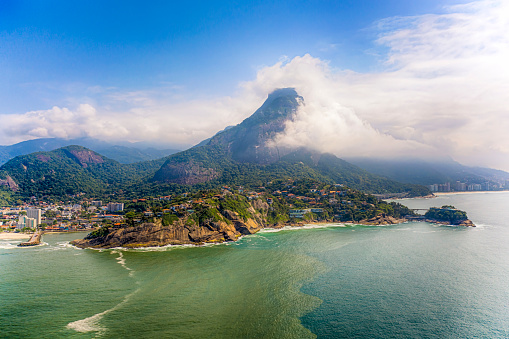 The coastilne,  the hills and some houses at Barra da Tijuca beach in a sunny day